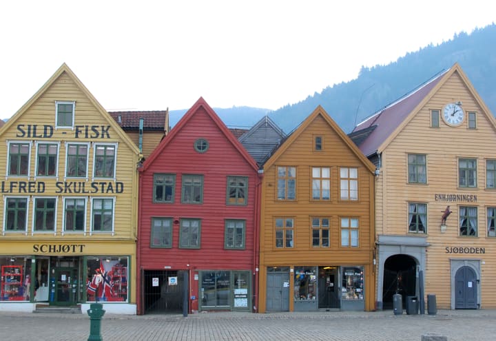Painted wooden facades of Bryggen in Bergen with shops at street level