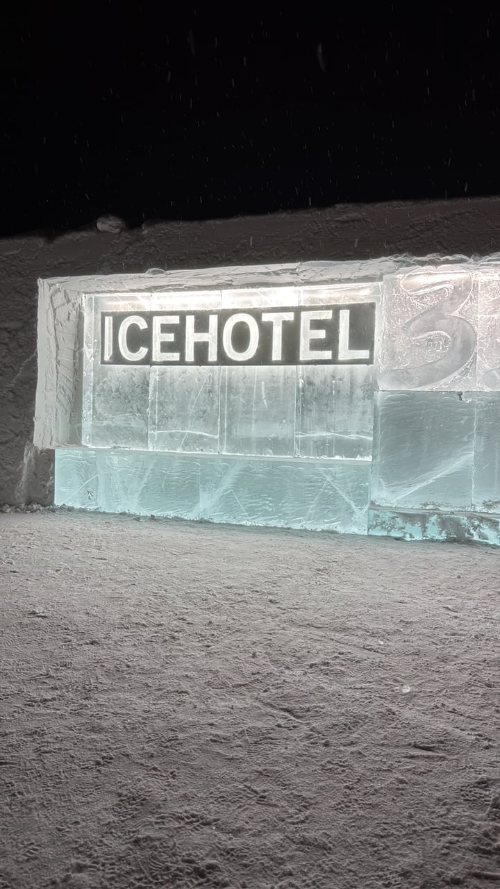 Ice hotel sign built into a snowy ice wall at night