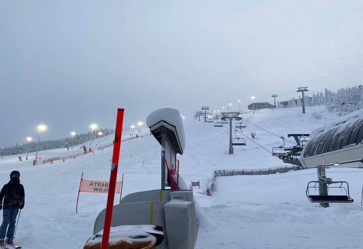 Floodlit ski slope and chairlift on the north side of Levi fell in winter