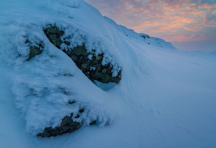 Blue hour over snow-crusted rocks on Lommoltunturi in Pallas-Yllästunturi National Park