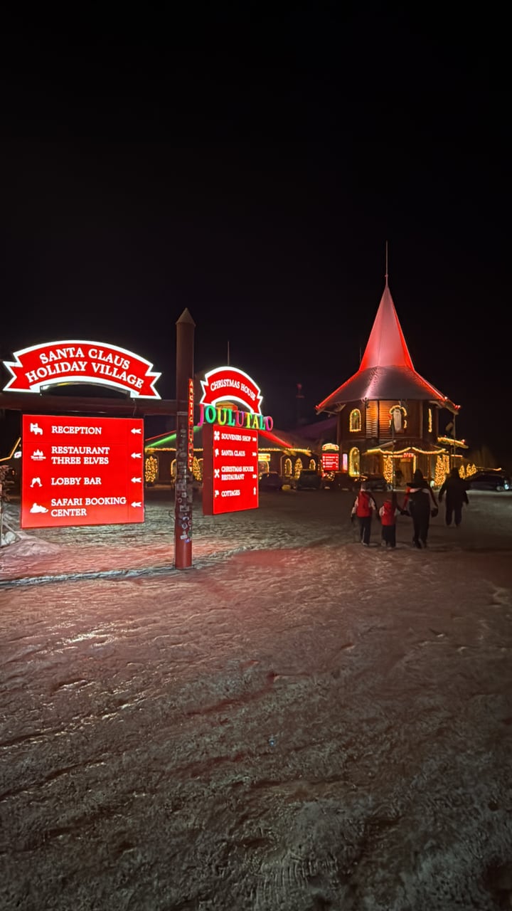 Santa Claus Holiday Village entrance lit at night in winter