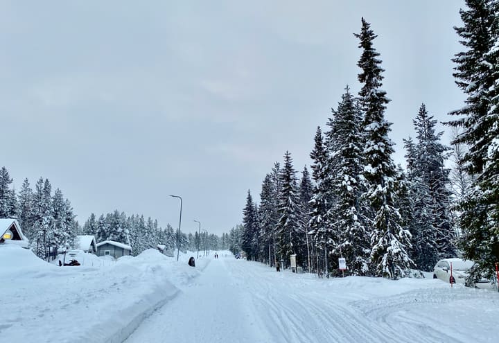 Snowy road and cabins in Äkäslompolo village below Ylläs in winter